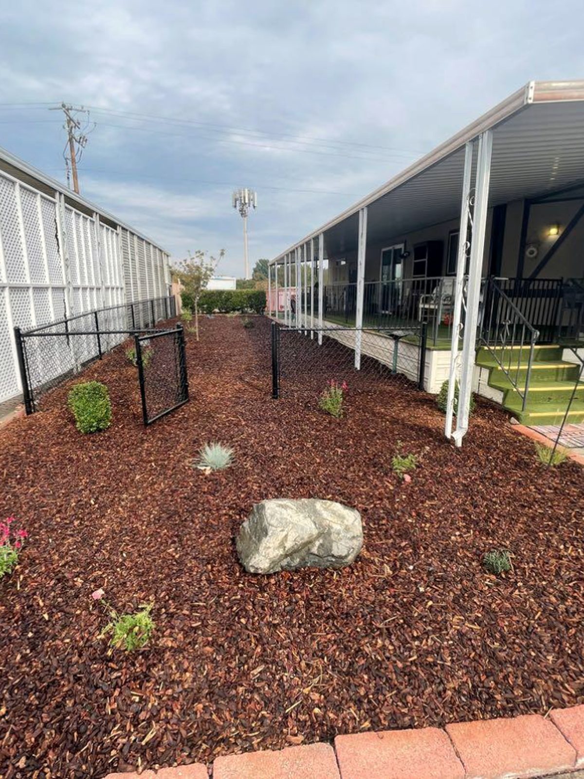 Drought-tolerant planting bed mulched with red lava rock, Southern Oregon